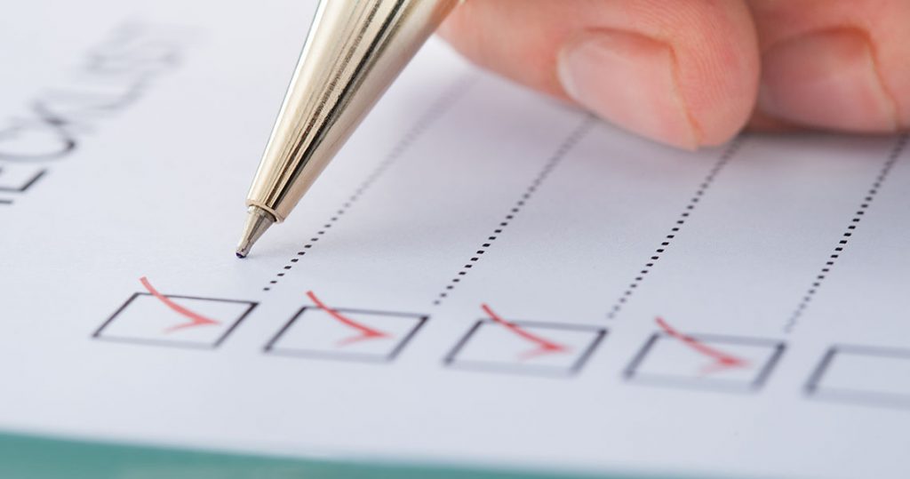 pen checking boxes to reassess Insurance Needs in Your Thirties and Beyond