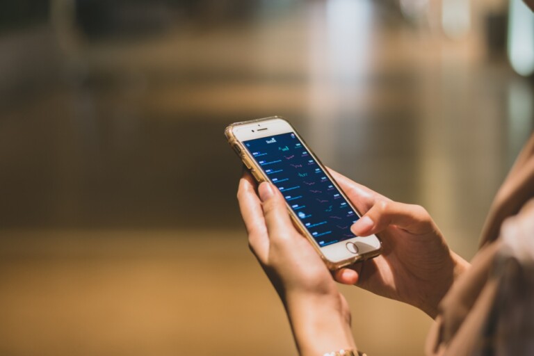 A detailed phone open on a table displaying charts on bonds, their risks, and benefits.
