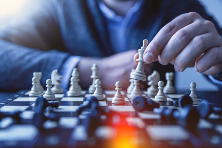 Planning the right coverage plan is like a game of chess, A financial advisor reviews a participating insurance policy with a client.